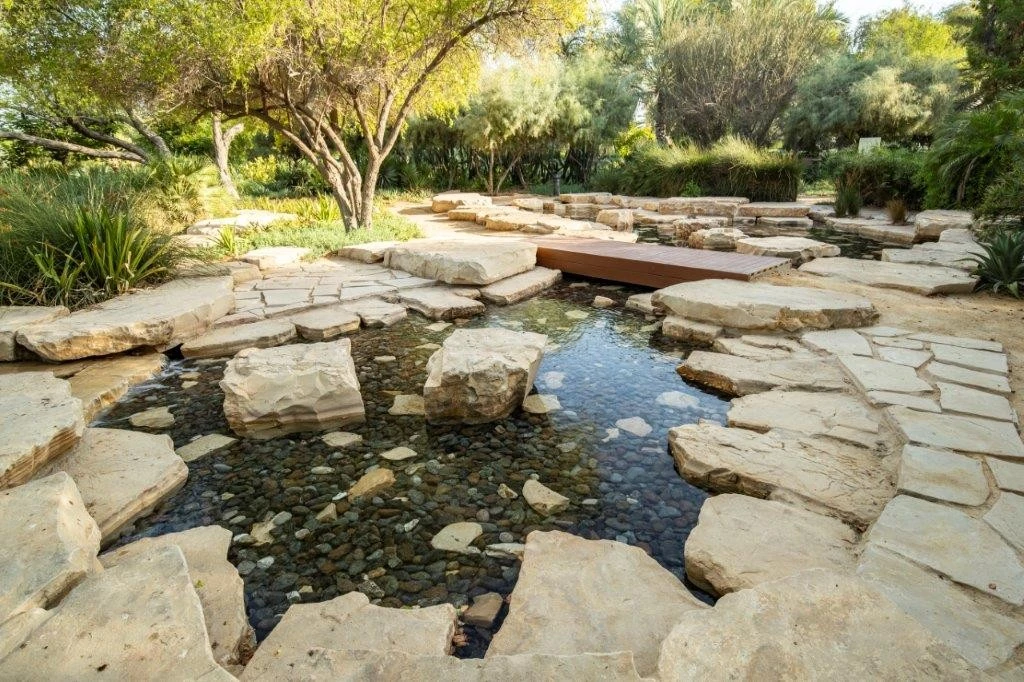 Stone pathway over stream in Umm Al Emarat Park, Abu Dhabi.