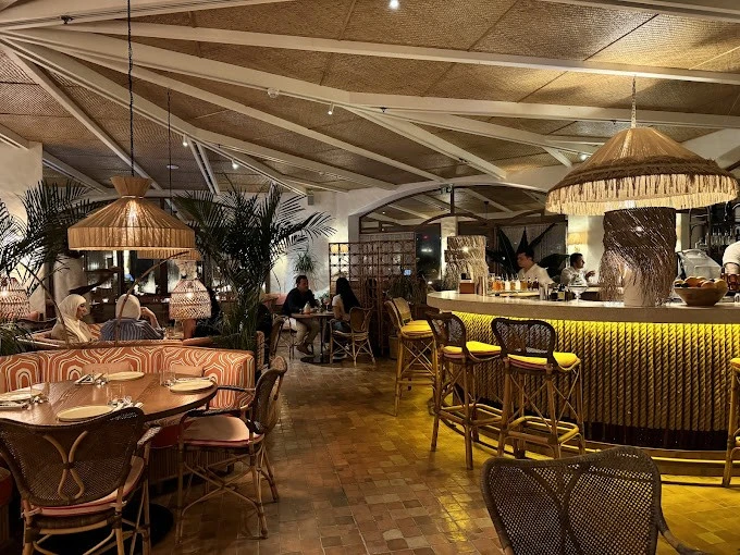 Tagomago Dubai restaurant interior with warm lighting and tropical decor.