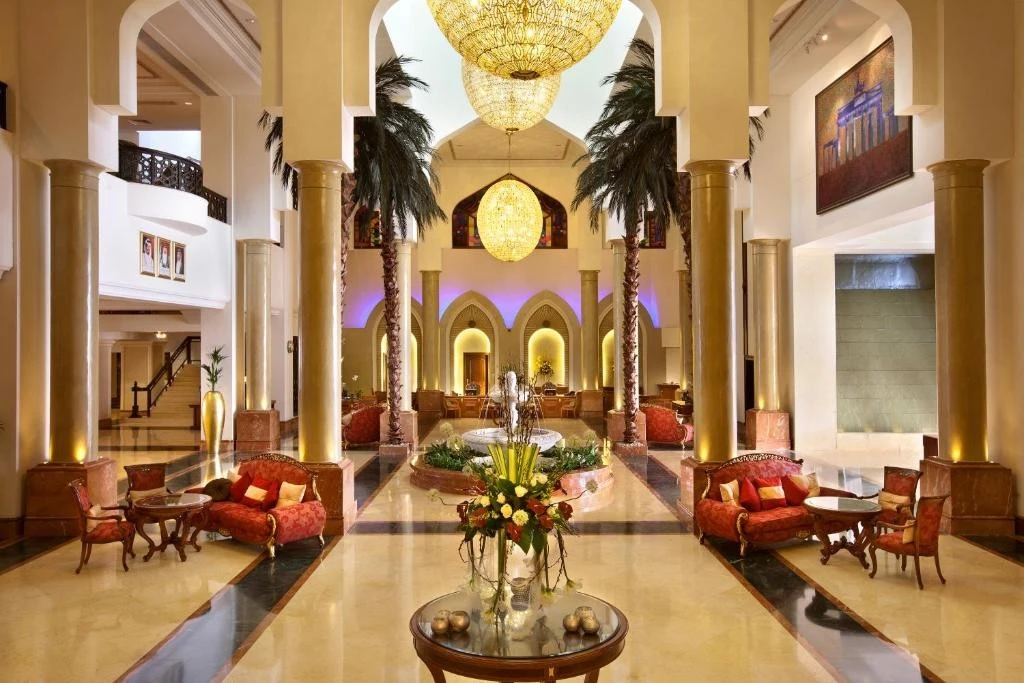 Luxurious lobby of Kempinski Hotel Ajman with elegant decor and lighting.