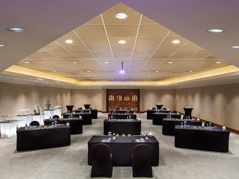Conference room setup at Kempinski Hotel Ajman with tables and chairs.