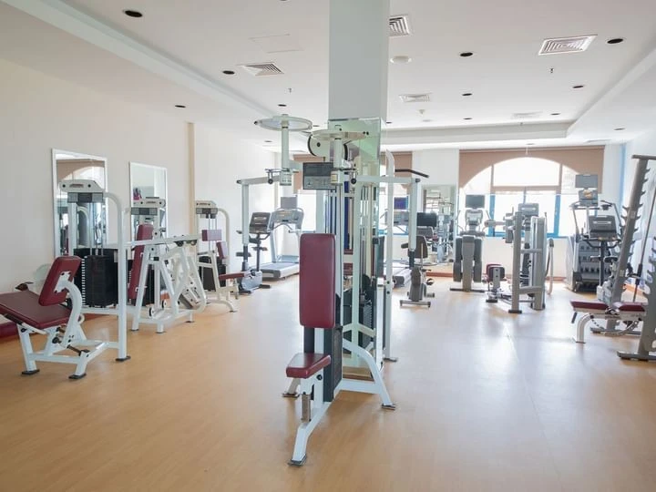 Kempinski Hotel Ajman gym with various exercise machines.