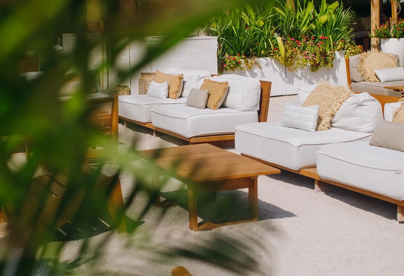 Outdoor seating area at Surf Club Dubai with lush greenery.