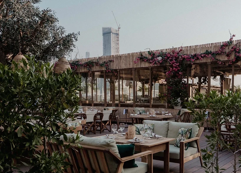Cozy outdoor lounge at Surf Club Dubai with skyscraper backdrop.