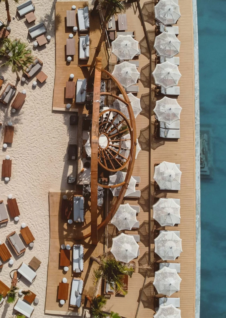 Aerial view of Be Beach DXB with umbrellas and seating, Dubai.