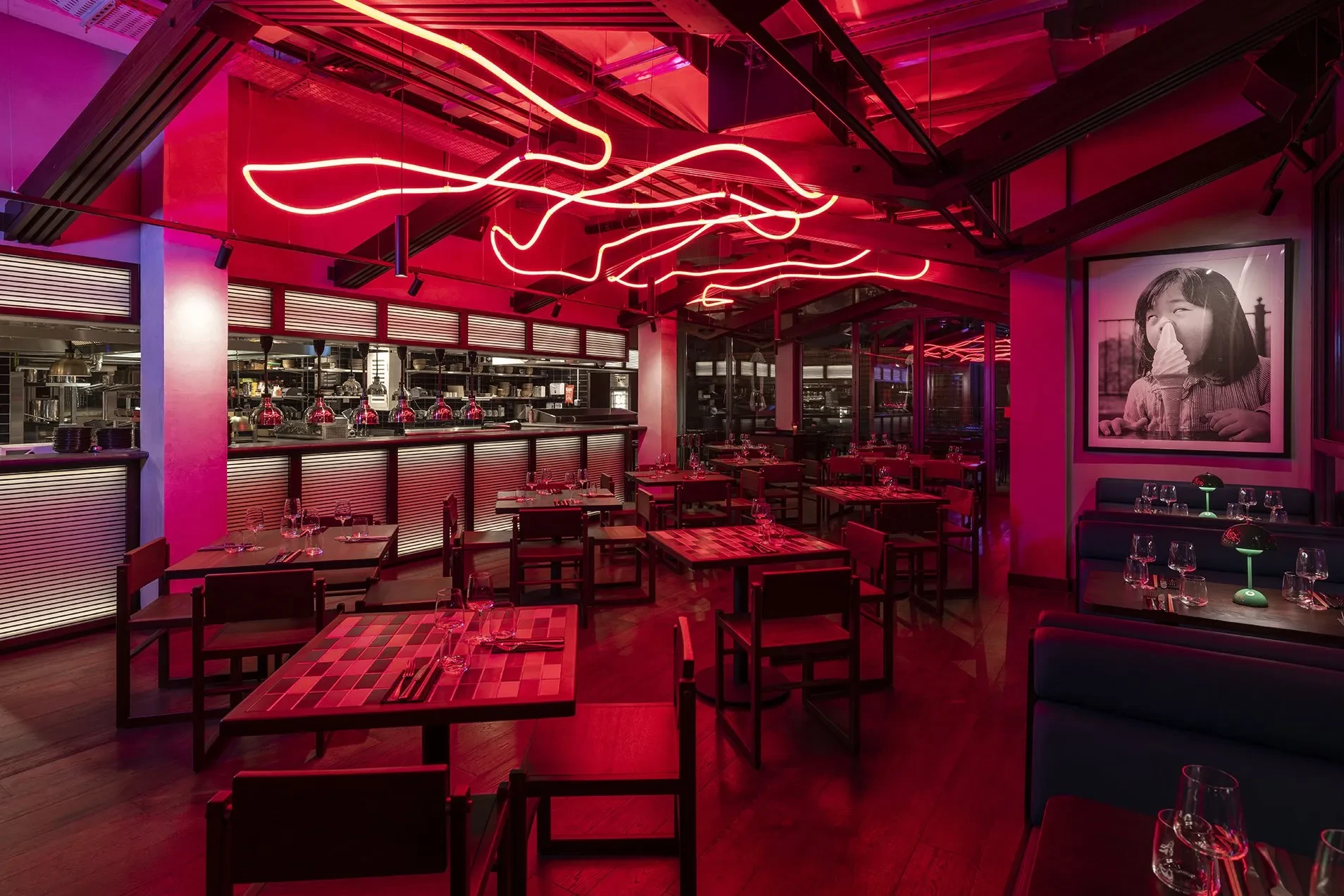 Hawkerboi restaurant interior with red lighting, Dubai.