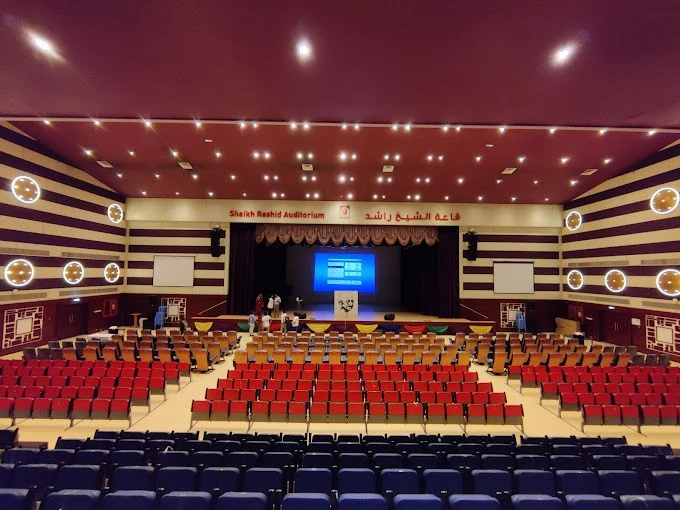 Sheikh Rashid Auditorium, Dubai, empty seating facing stage with screen.