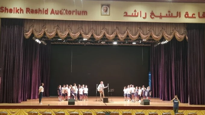 Children performing on stage at Sheikh Rashid Auditorium, Dubai.