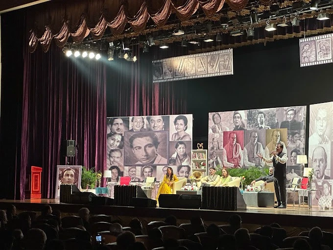 Stage performance at Sheikh Rashid Auditorium, Dubai with actors and portraits.