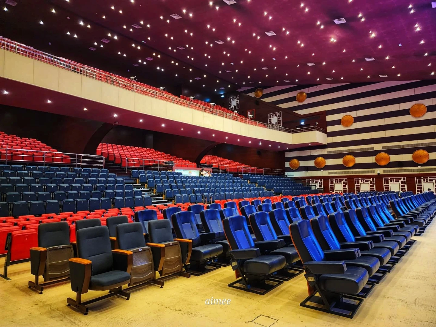 Sheikh Rashid Auditorium seating, colorful chairs, Dubai venue interior.