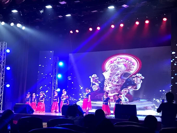Dance performance at Sheikh Rashid Auditorium, Dubai with vibrant stage lighting.