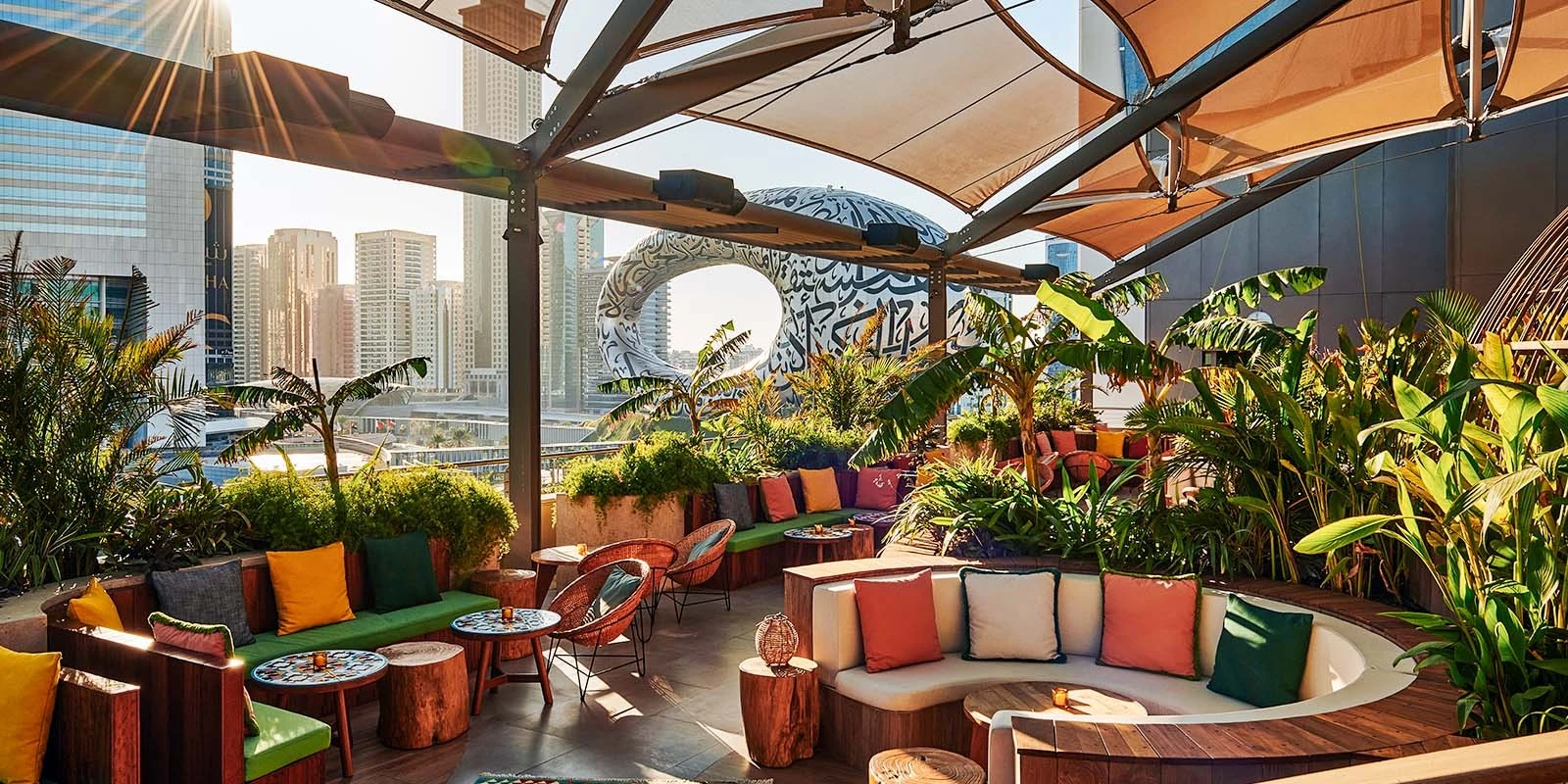 Lush rooftop seating at Monkey Bar Dubai with city view.