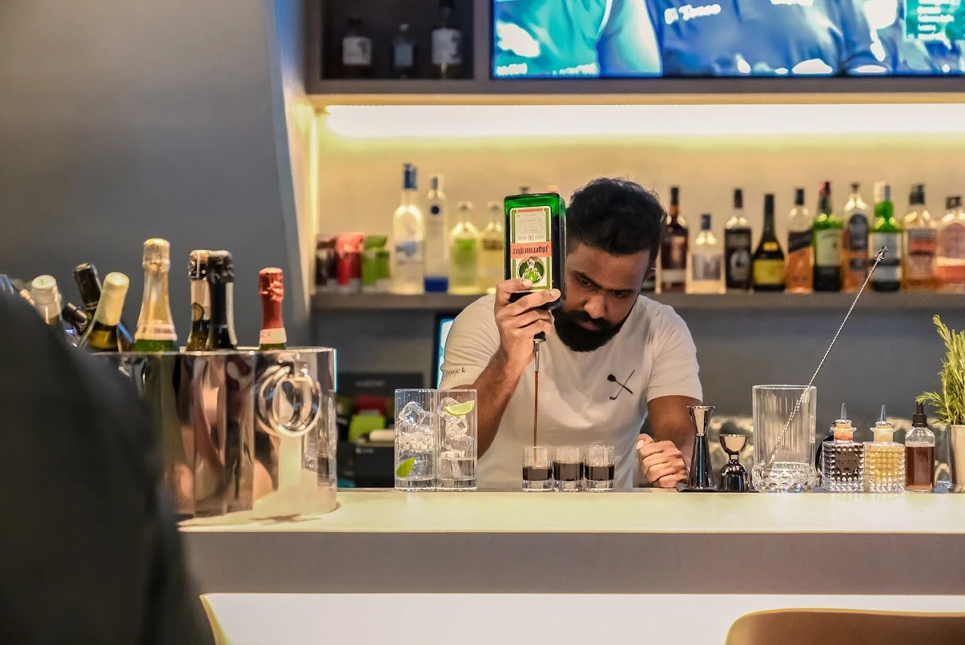 Bartender preparing drinks at Bedrock Pier 7, Dubai bar.