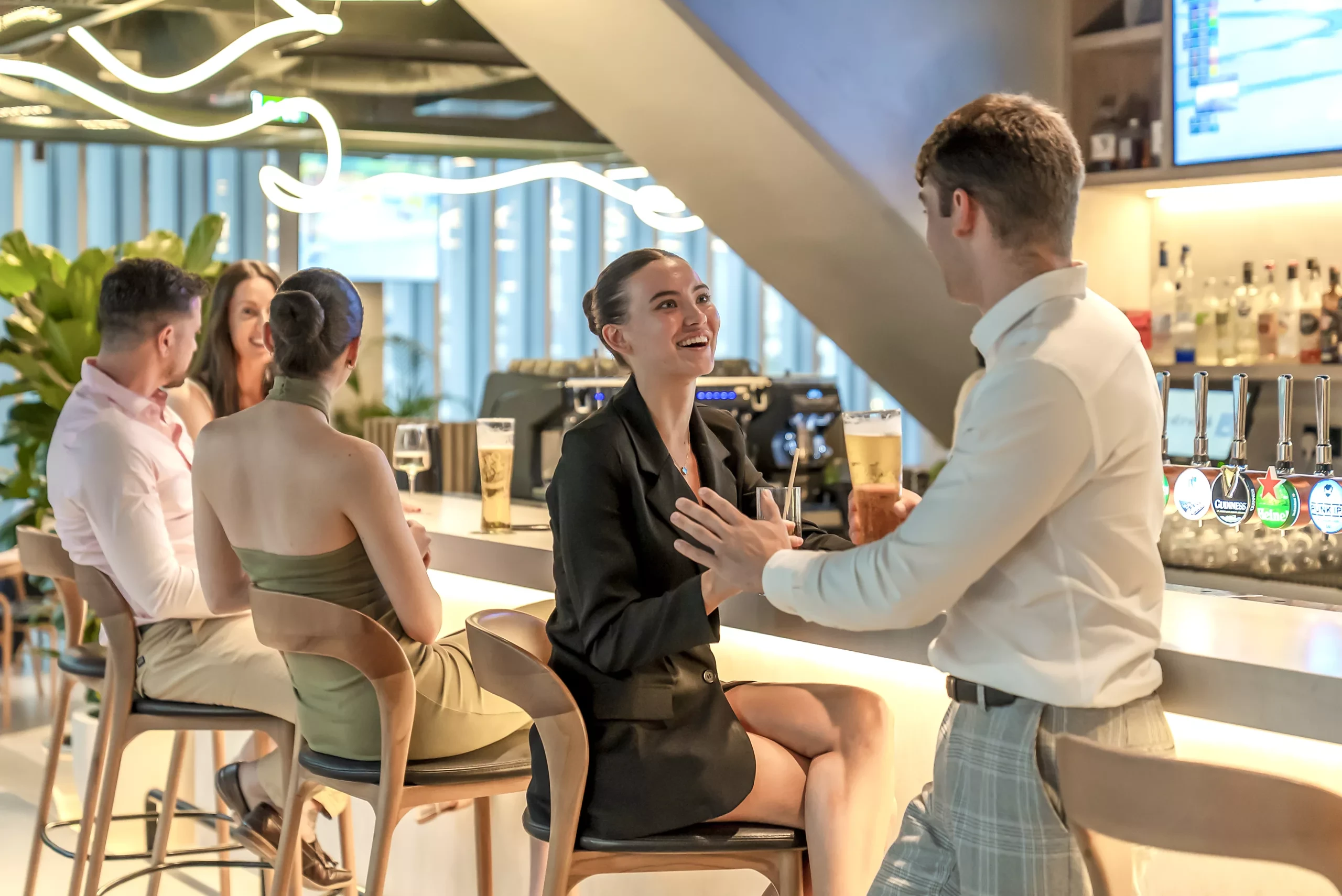 People socializing at Bedrock Pier 7 bar in Dubai.