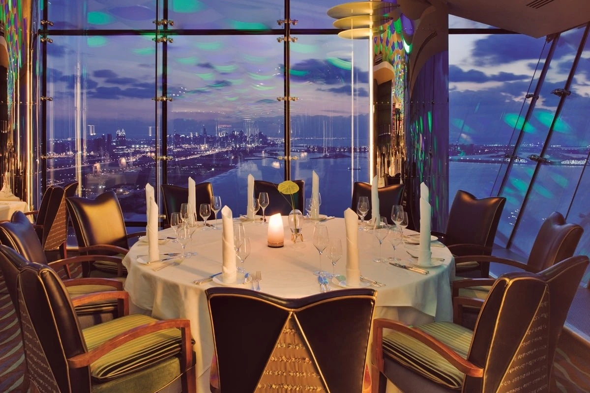 Elegant dining setup at Al Muntaha, Dubai with city view.