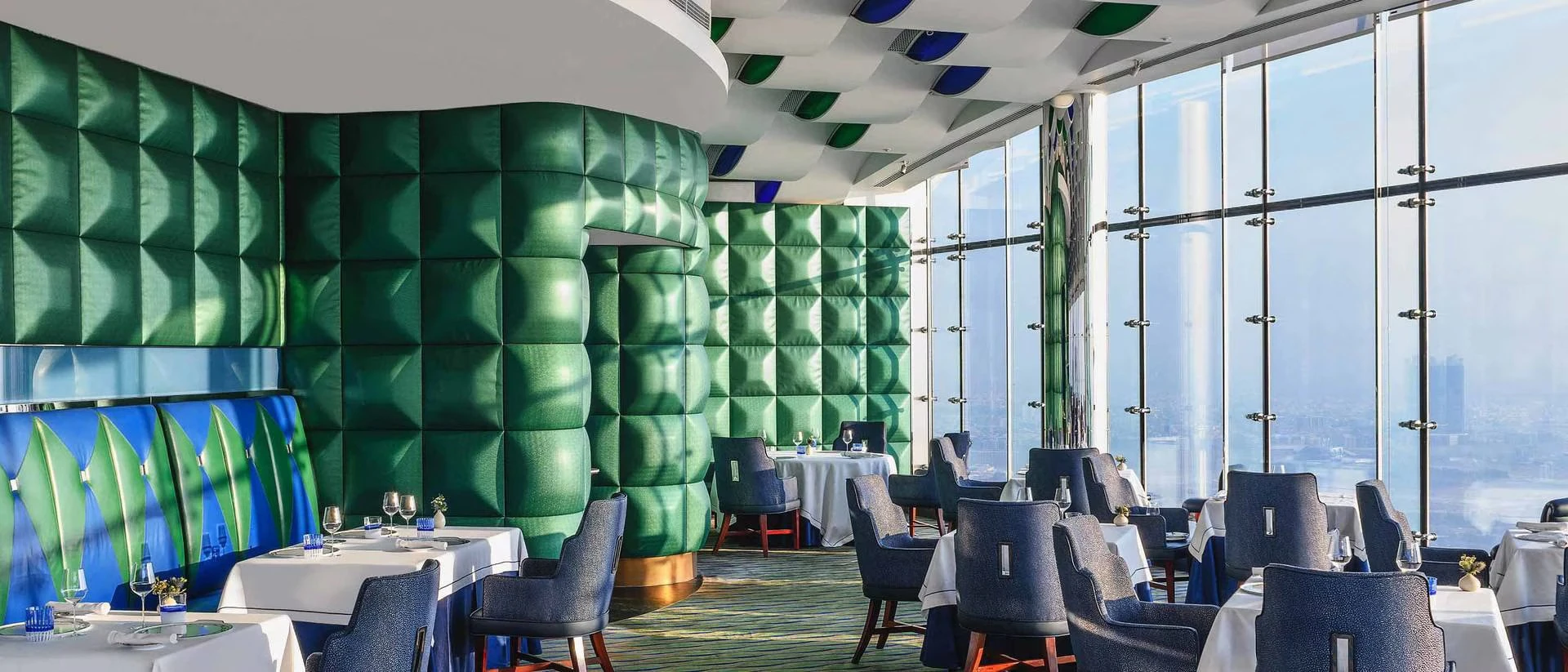 Elegant dining area at Al Muntaha, Dubai with panoramic city views.