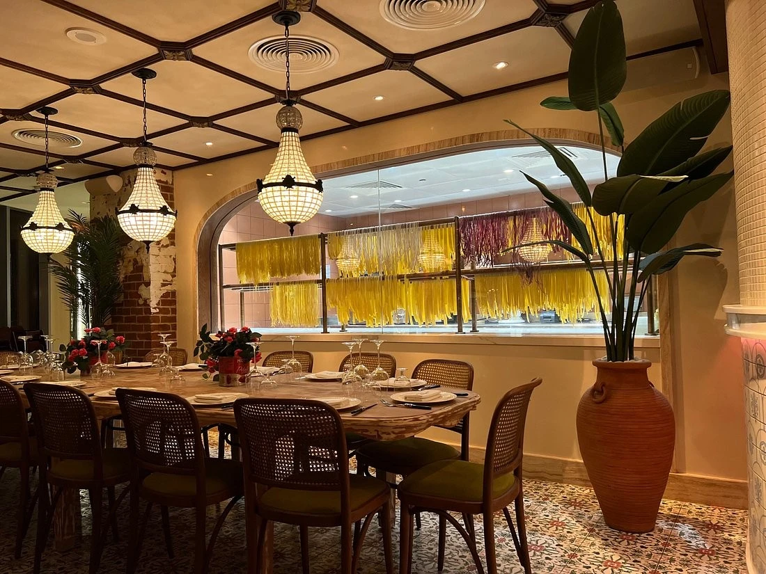 Elegant dining area at Papas Dubai Marina with hanging pasta display.