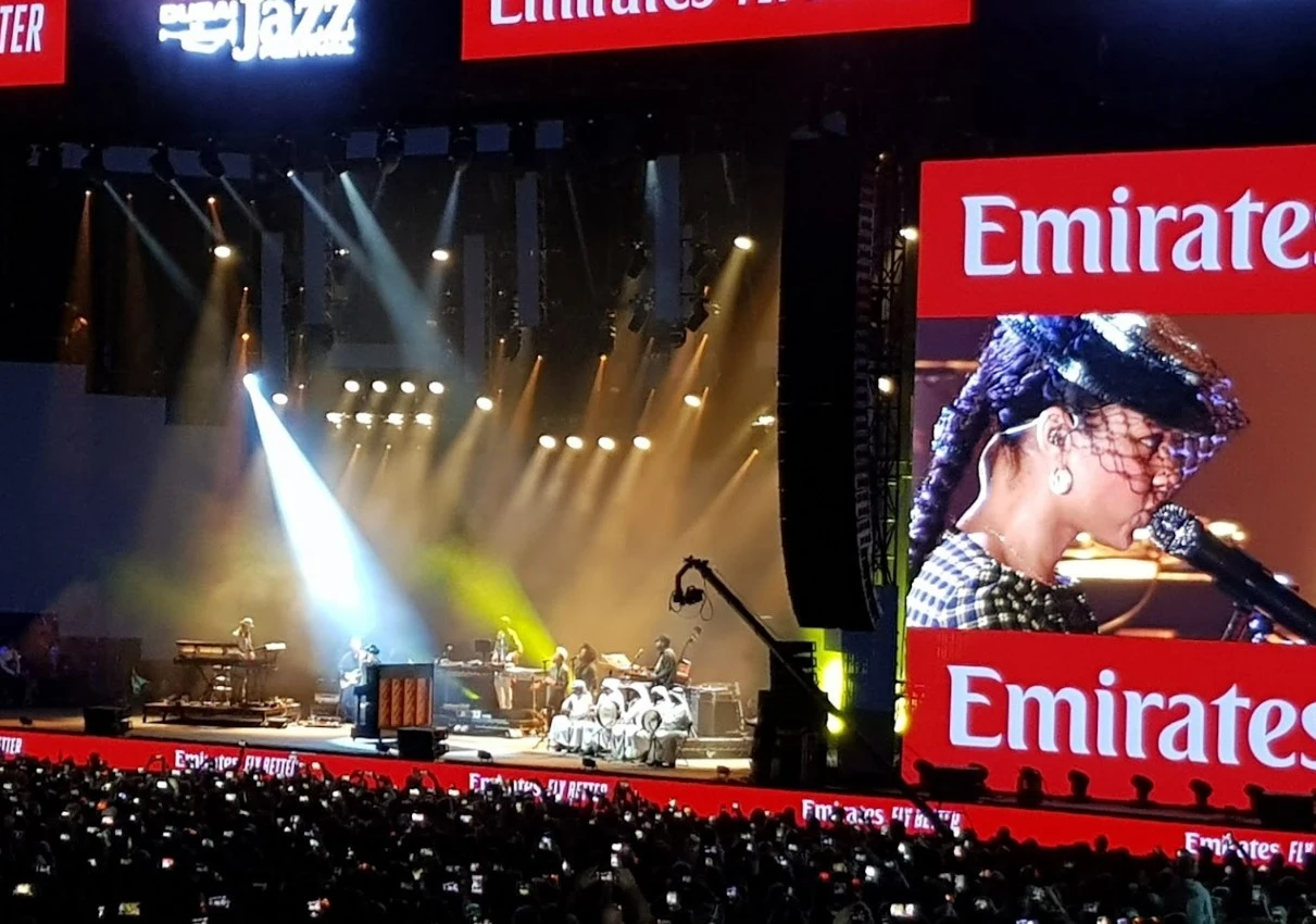 Concert at Dubai Media City Amphitheatre with large audience and stage lights.