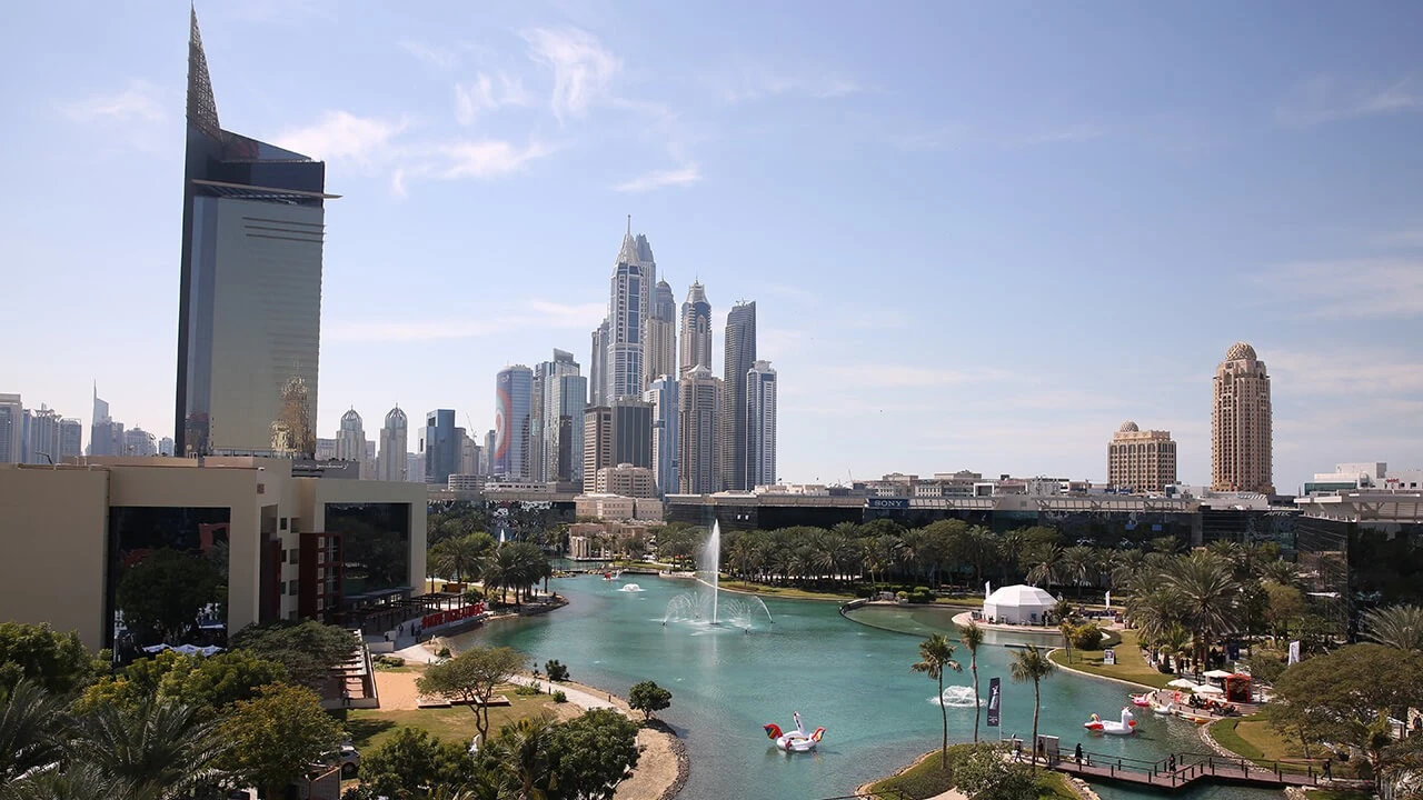 Dubai Media City Amphitheatre with skyscrapers and water feature, Dubai skyline.