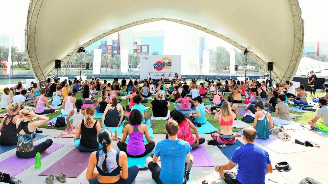 Yoga class at Dubai Media City Amphitheatre, outdoor gathering.