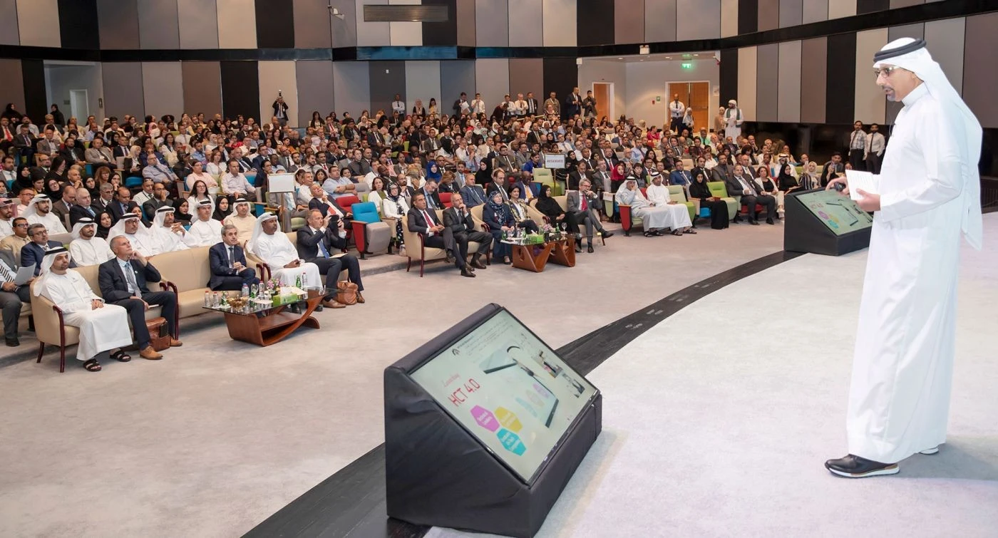 Speaker addressing audience at Hct Dubai Al-Nahda Campus Auditorium.
