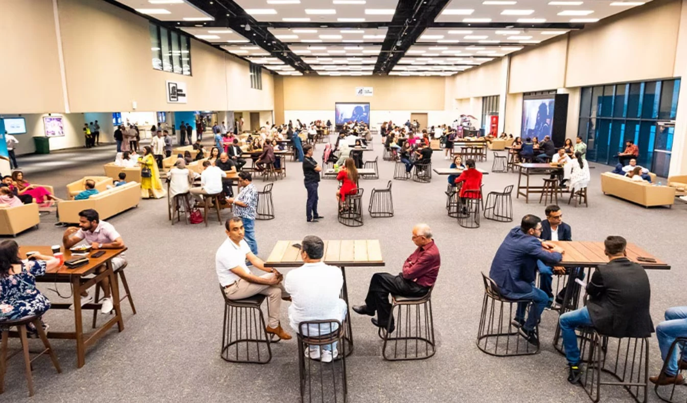 People socializing at Etihad Arena lounge, Abu Dhabi.