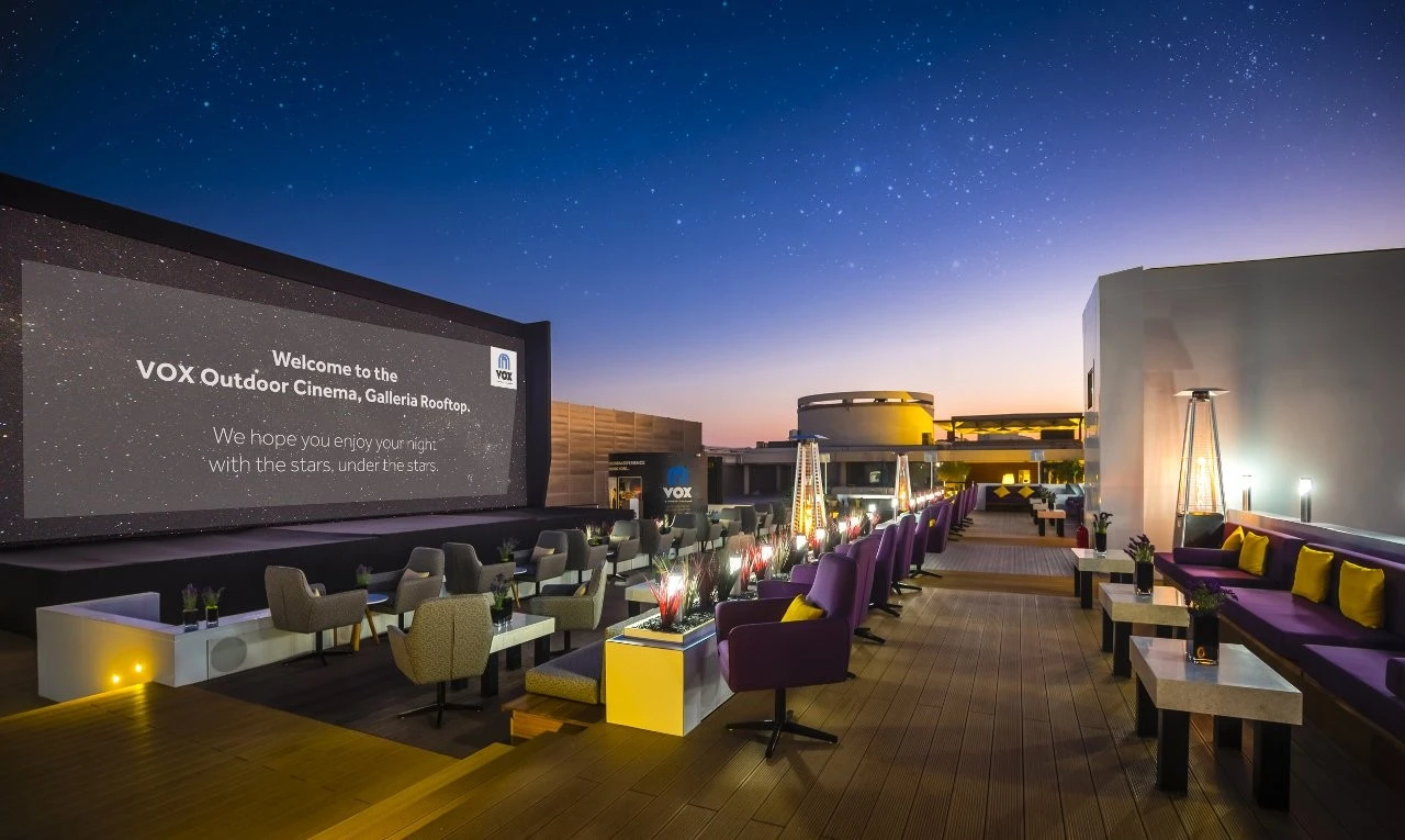 VOX Moonlight Dubai outdoor cinema with seating under starry sky.
