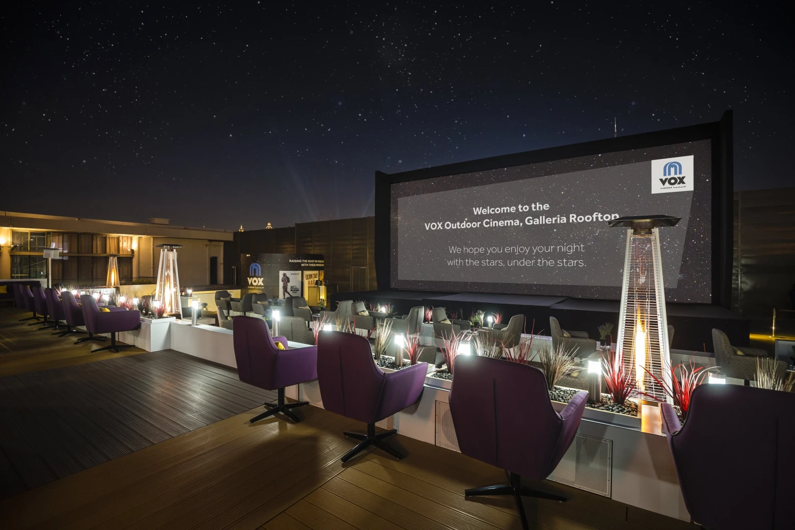 VOX Moonlight outdoor cinema with seating, Dubai night sky backdrop.