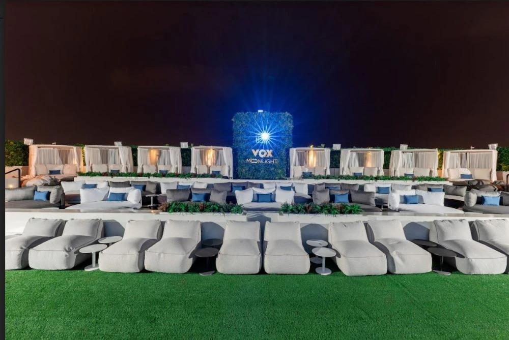 Outdoor seating at VOX Moonlight, Dubai, under night sky.