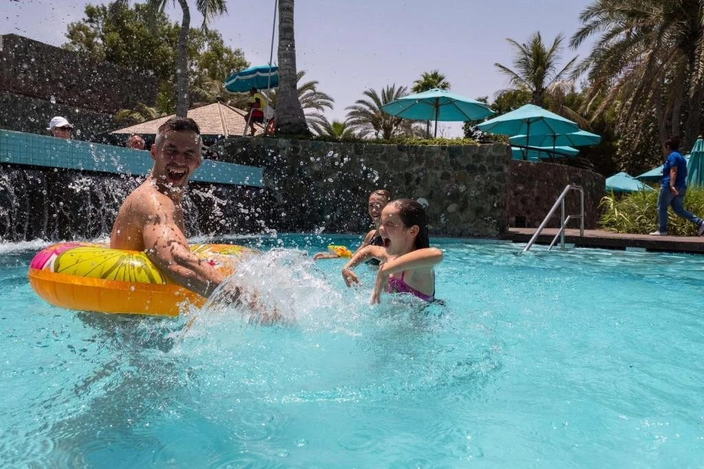 People enjoying pool at JA Beach Hotel, Dubai.