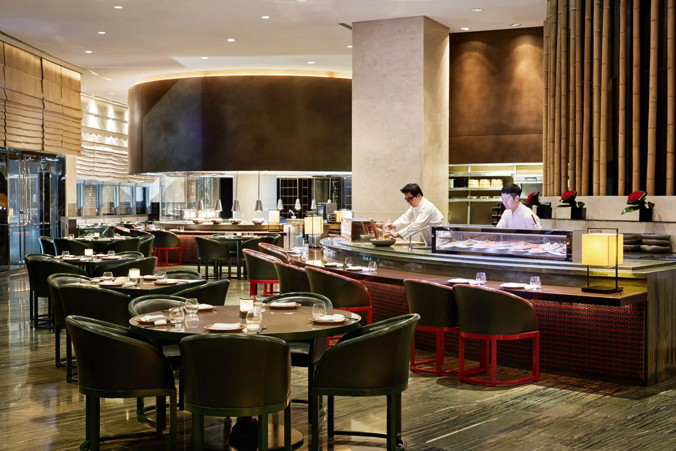 Elegant sushi restaurant at Armani Hotel Dubai with chefs preparing dishes.