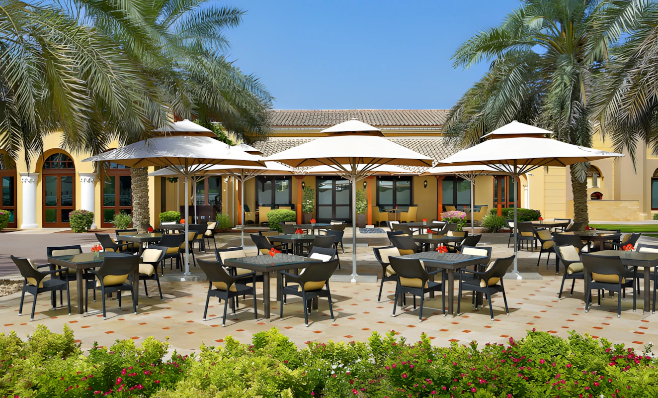 Outdoor terrace at Dubai Polo & Equestrian Club with umbrellas.
