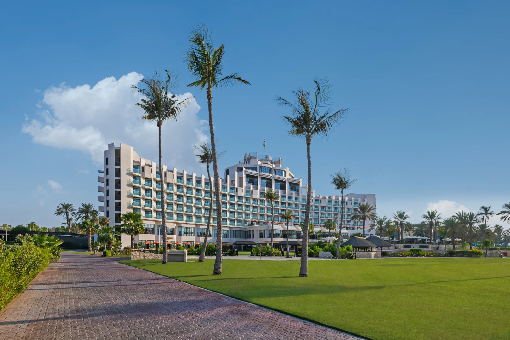JA Beach Hotel exterior with palm trees, Dubai.