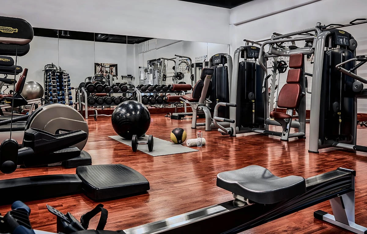 Modern fitness center at The Meydan Hotel, Dubai with gym equipment.