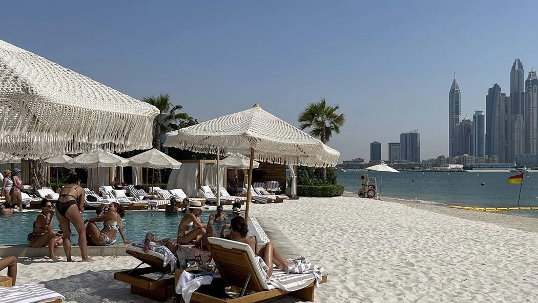 Kyma Beach Dubai with loungers, umbrellas, and city skyline view.