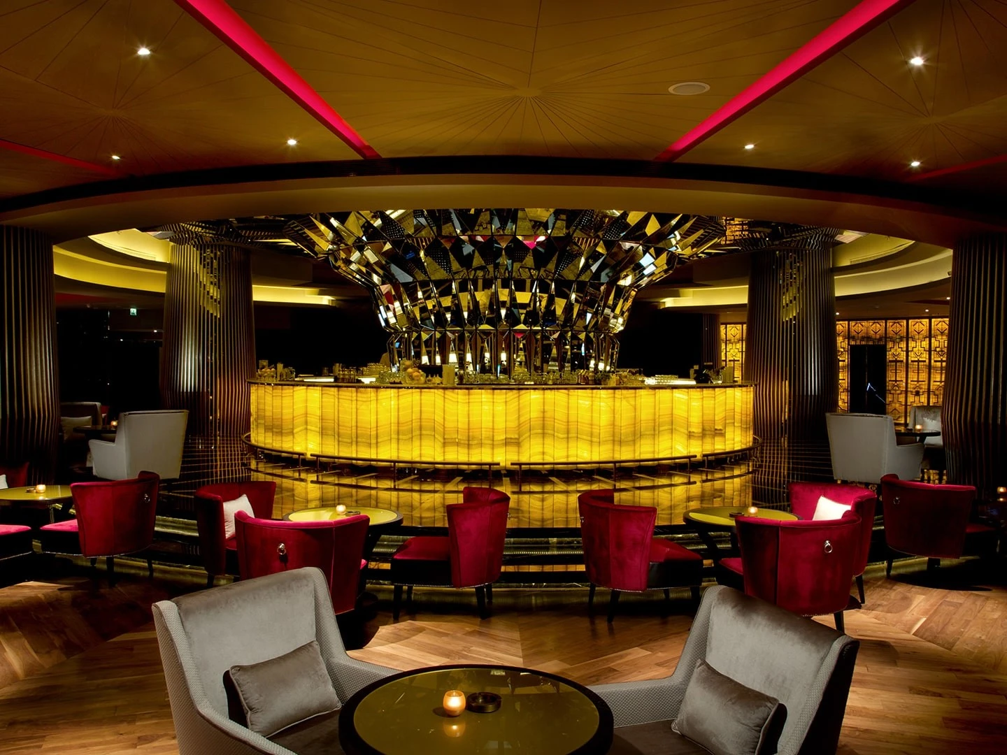 Luxurious interior of Atelier M lounge with vibrant lighting, Dubai.