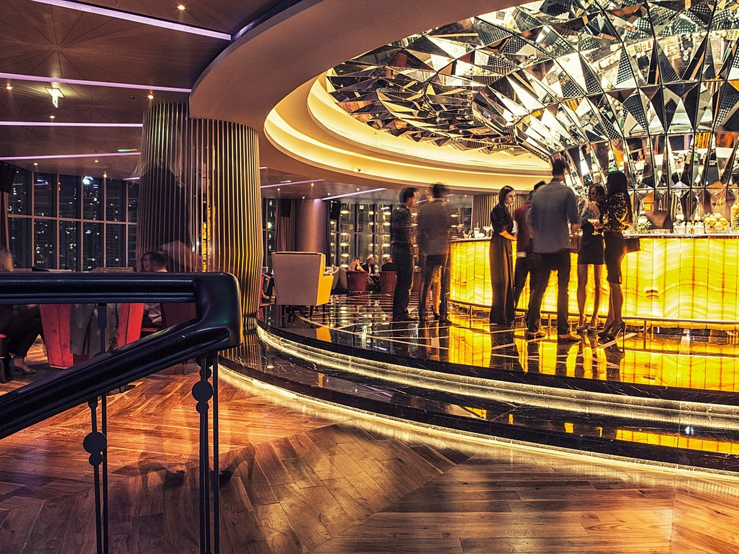 Elegant bar interior at Atelier M, Dubai with patrons socializing.
