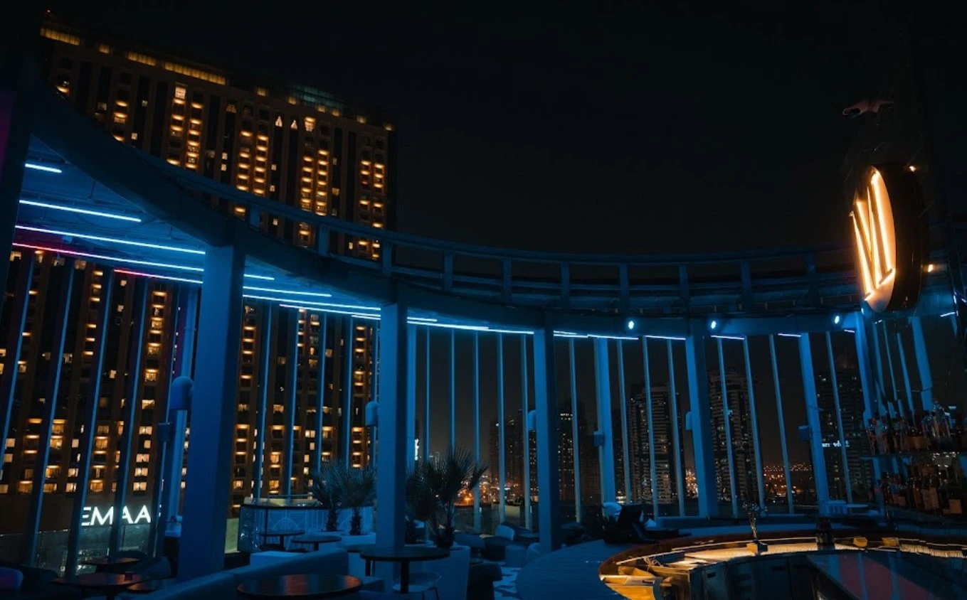 Atelier M rooftop bar with city skyline view, Dubai at night.