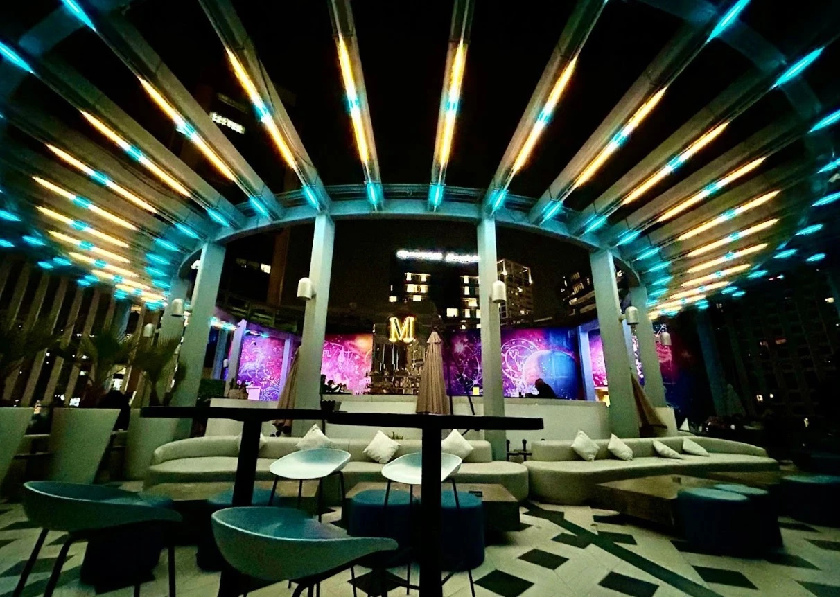 Atelier M rooftop lounge with colorful lighting in Dubai.