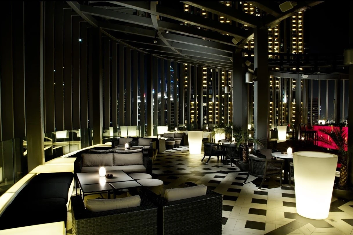 Elegant rooftop lounge at Atelier M, Dubai, with city views.