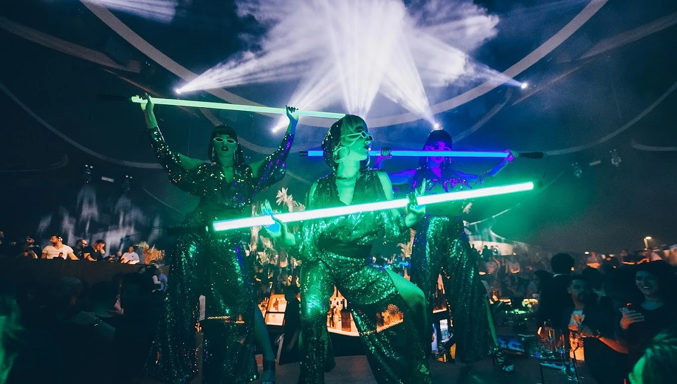 Performers with neon lights at Sky2.0 Dubai nightclub.