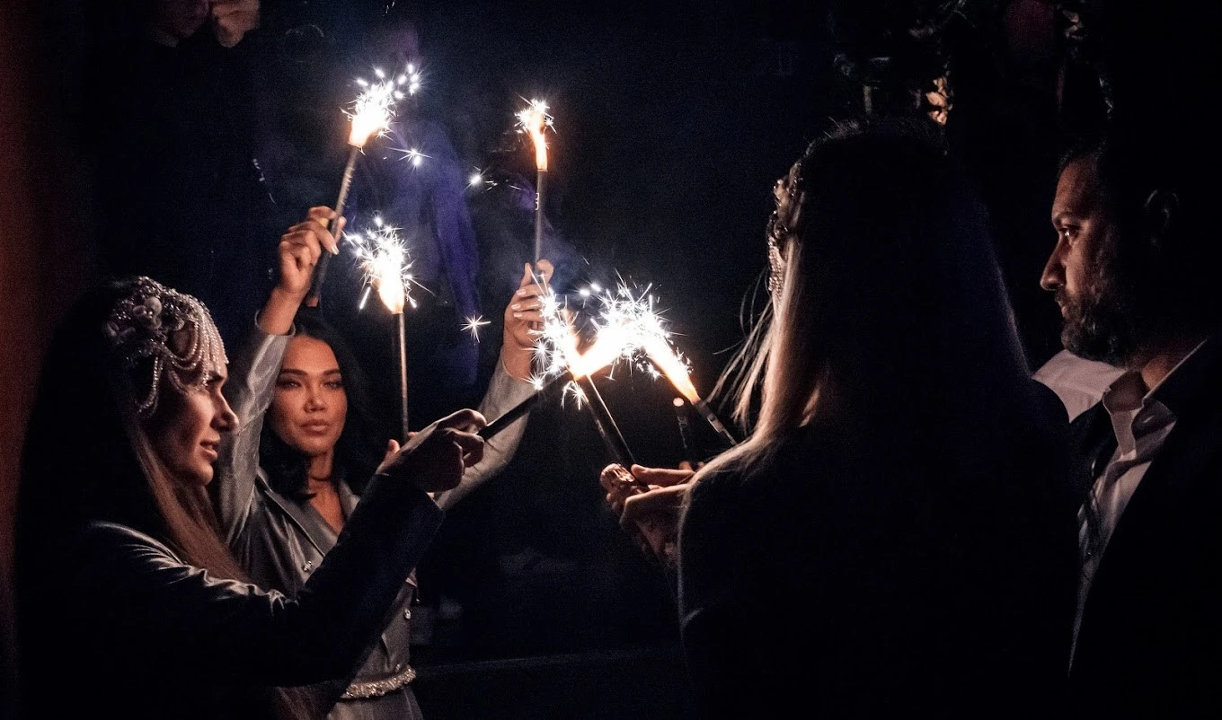 People holding sparklers at Sky2.0 Dubai event.