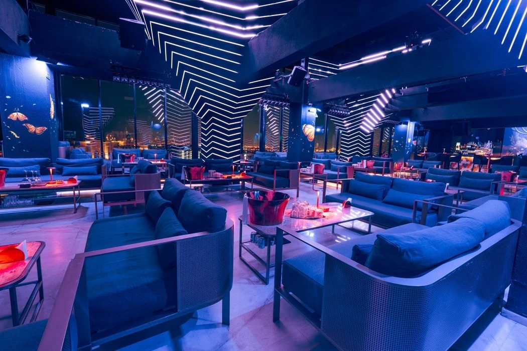 The Penthouse Dubai lounge with modern seating and neon lighting.
