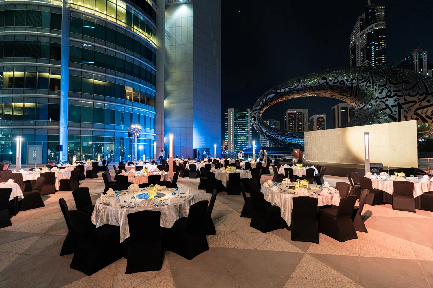 Elegant outdoor dinner setup at Jumeirah Emirates Towers, Dubai.