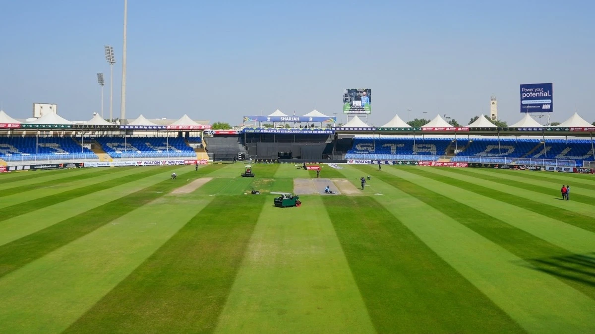 Sharjah Cricket Stadium with green field and empty stands.