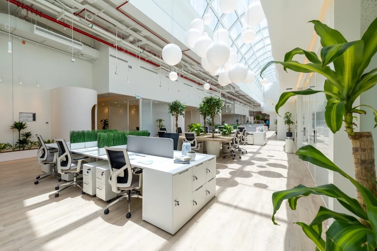 Modern coworking space at Cloud Spaces Circle Mall Dubai with plants.
