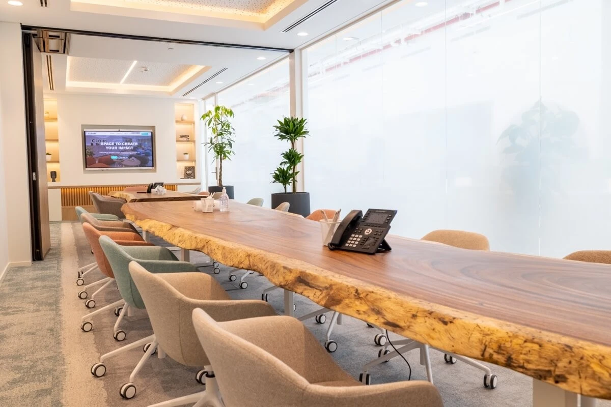 Long wooden conference table with chairs, Cloud Spaces Dubai.
