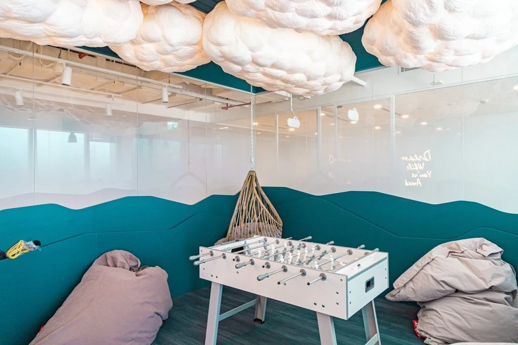 Foosball table and bean bags under cloud lights, Cloud Spaces ADGM, Abu Dhabi.