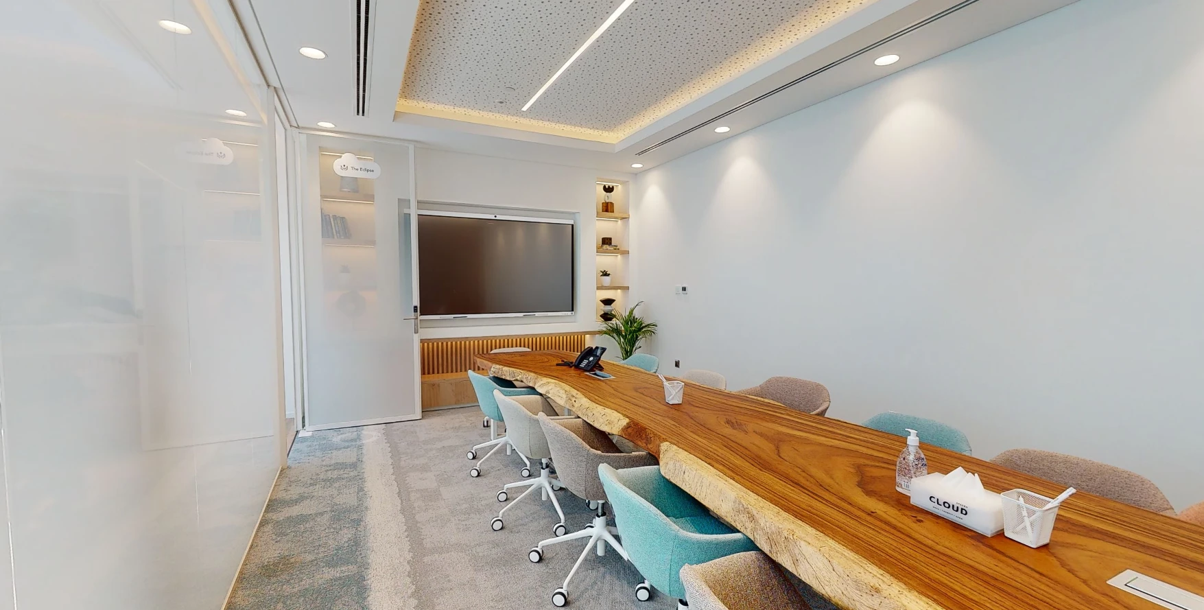 Contemporary meeting space with large wooden table, Cloud Spaces Dubai.