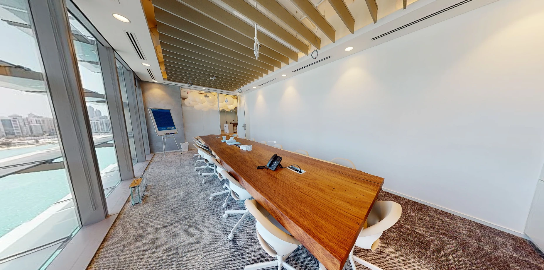 Modern conference room at Cloud Spaces ADGM, Abu Dhabi with city view.