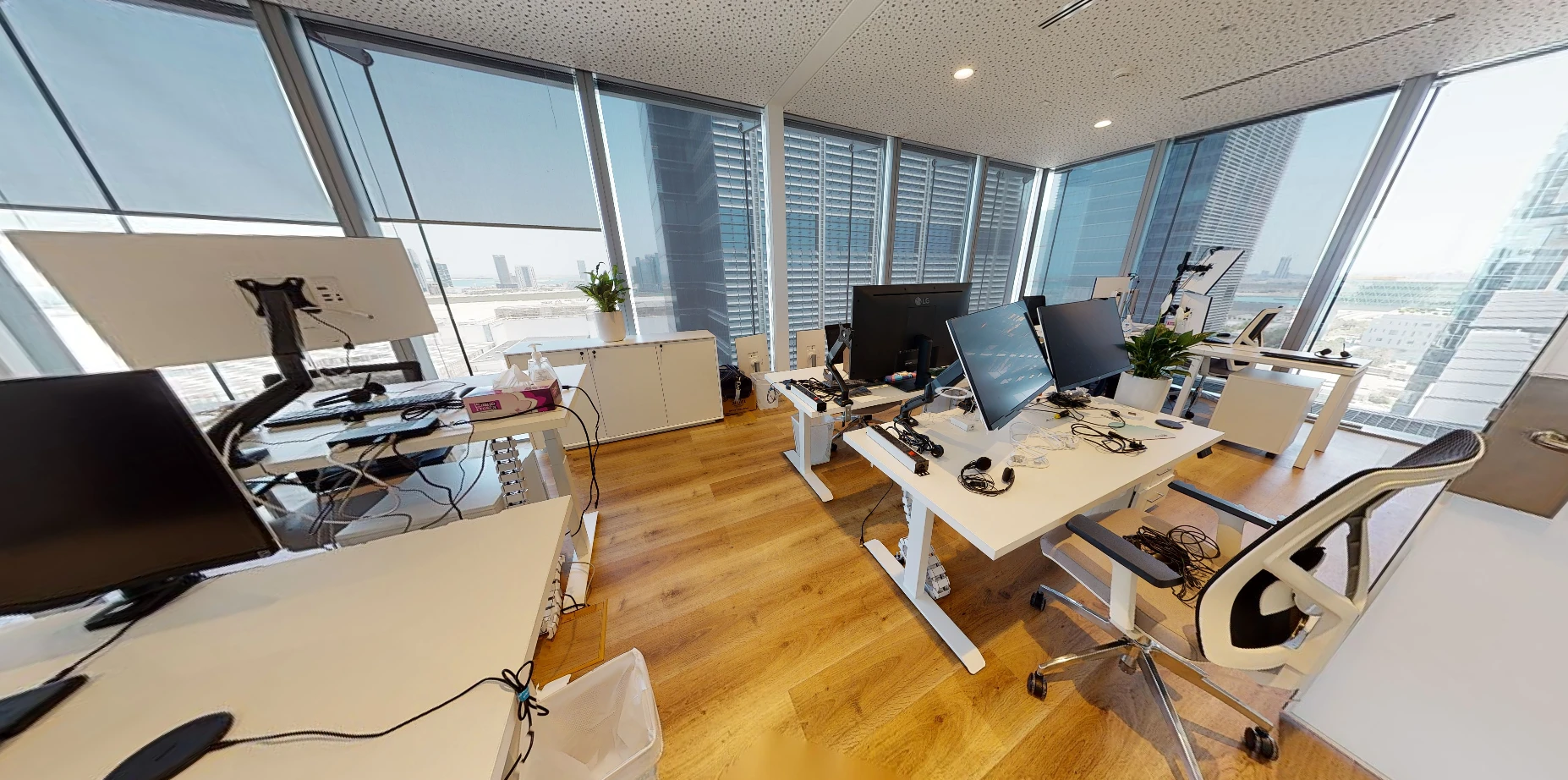 Modern office space at Cloud Spaces ADGM, Abu Dhabi with large windows.